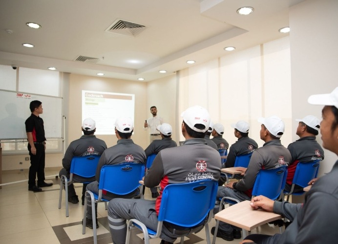 TRAP pest control employees in sitting in one room listening to an expert explaining more about pest control