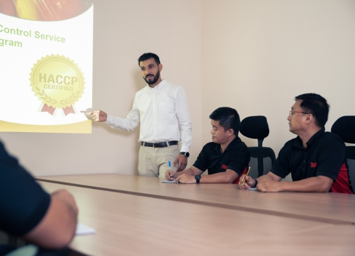 A trainer at TRAP pest control conference room training employees